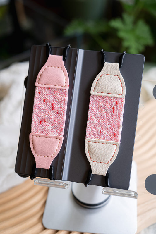 Kittentailor Original Strawberry Cake Kindle strap featuring durable black metal clips and creamy white vegan leather. Double-layer pink elastic with unique speckled pattern creating a sweet and romantic style.