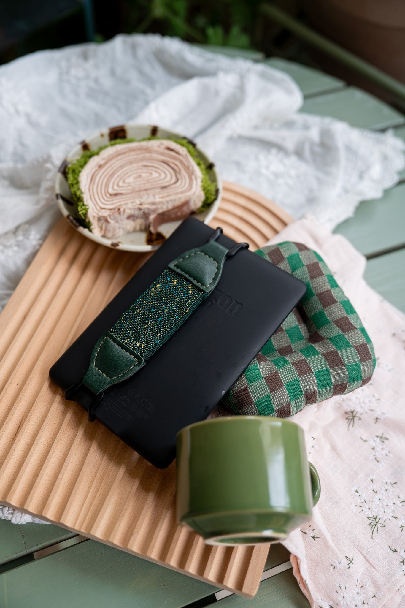 Kittentailor handmade Forest Green Kindle grip strap with black metal buckles. Unique speckled pattern PU leather for a professional yet playful nature aesthetic.