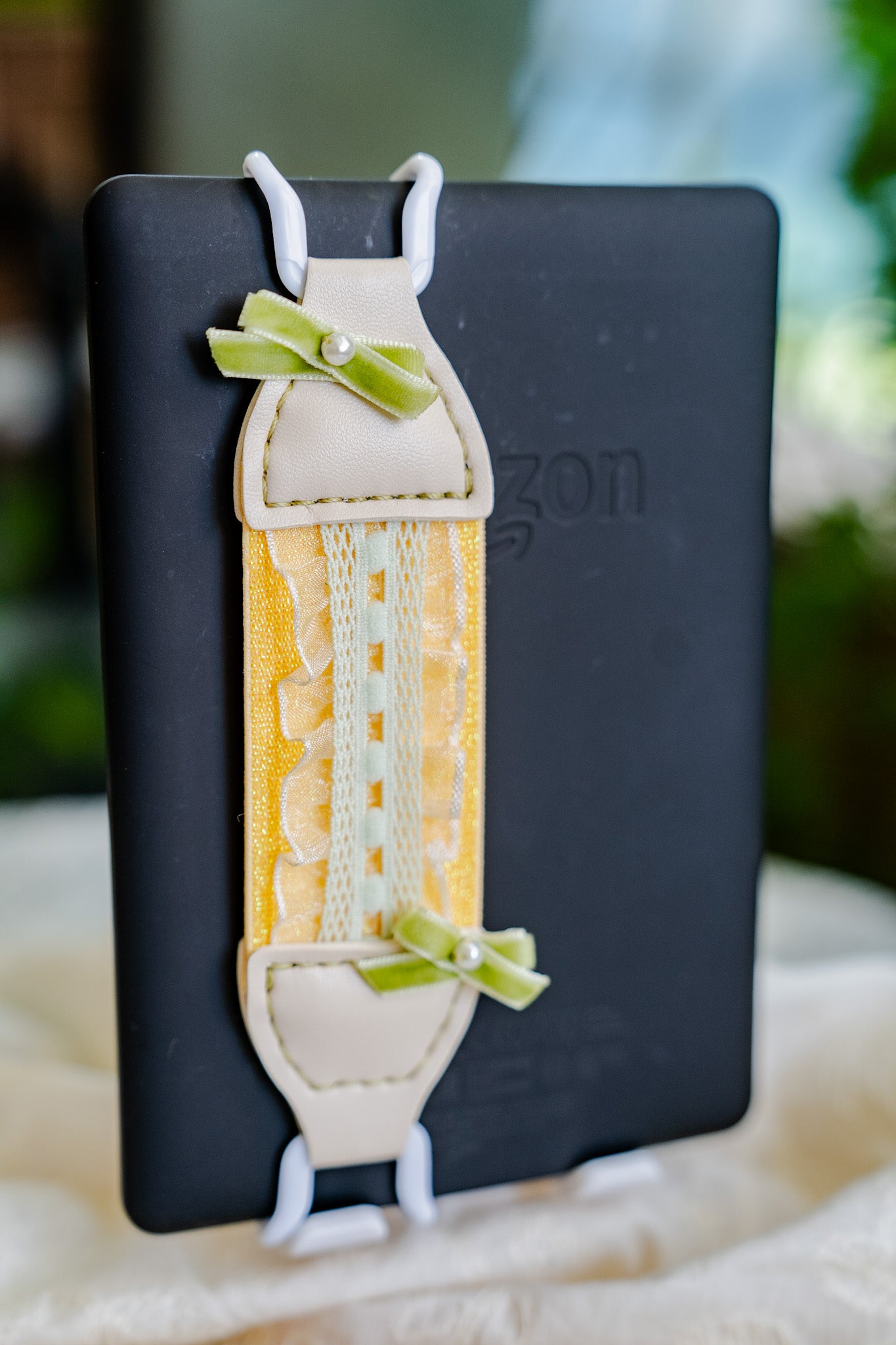 Chic and Coquette design detail of Kittentailor handmade Lemon Daylight strap. Trendy yellow vegan leather texture for a stylish reading experience.