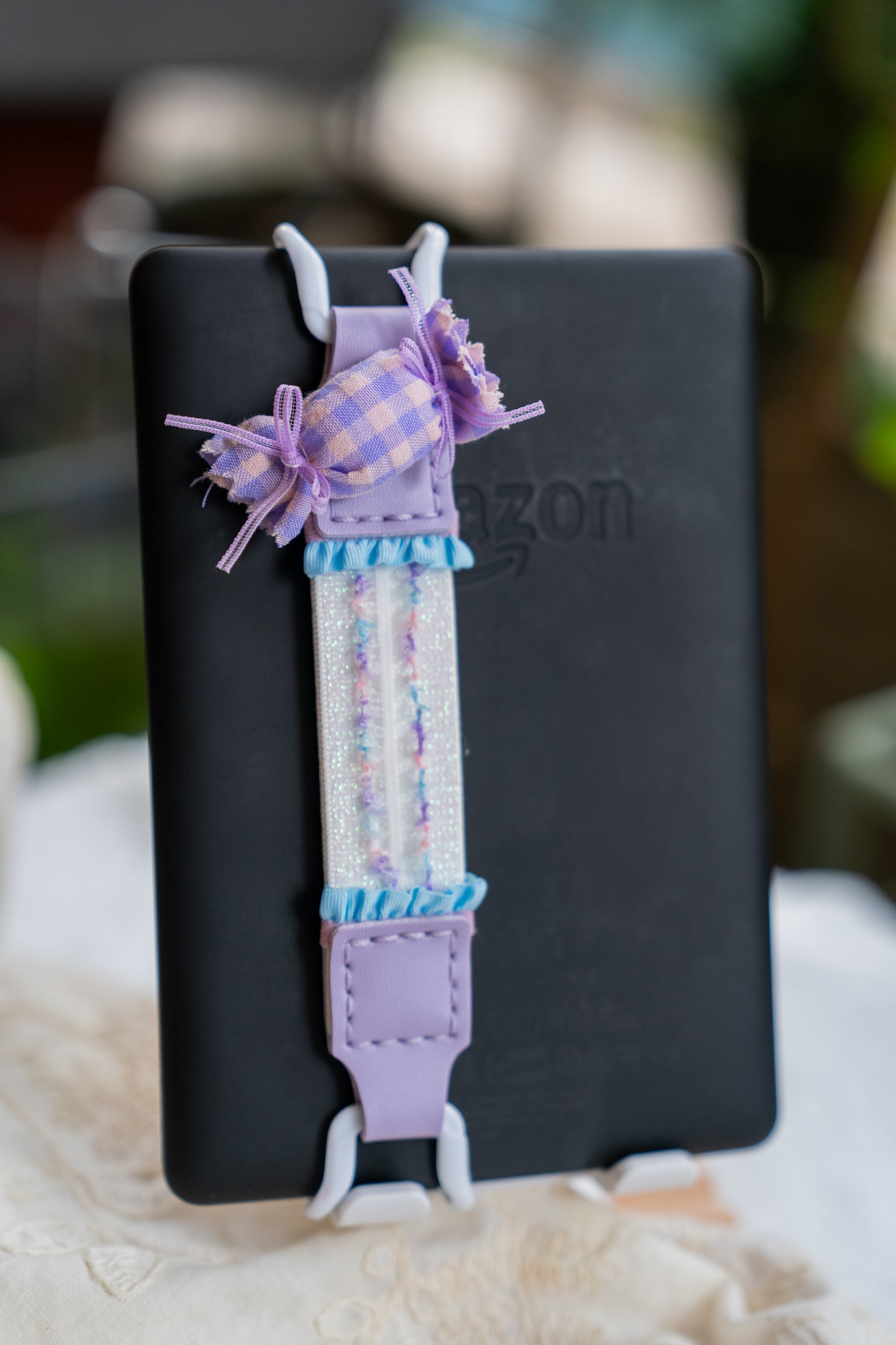 Kittentailor aesthetic reading accessory to prevent pinky cramps for avid Kindle users. A sophisticated choice for lifestyle lovers adding charm to e-readers.